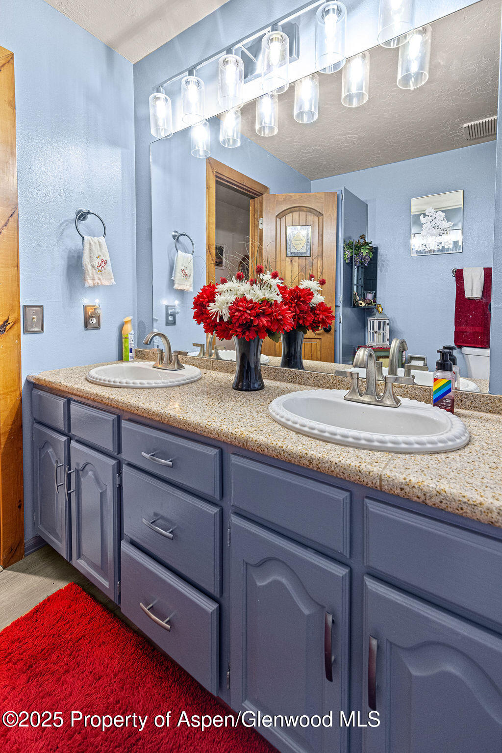 2928 Pinon Circle Craig, CO 81625 - Photo 57 of 92 a en suite bathroom with a sink double vanity and a mirror