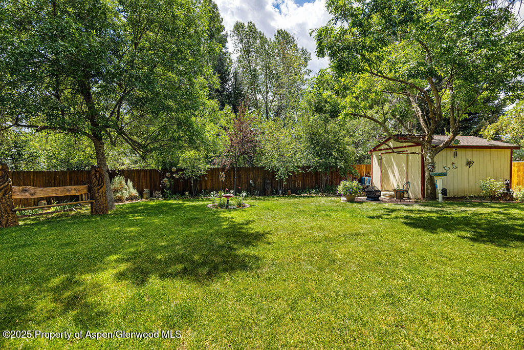 2928 Pinon Circle Craig, CO 81625 - Photo 78 of 92 a view of backyard with table and chairs and wooden fence