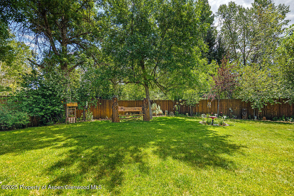 2928 Pinon Circle Craig, CO 81625 - Photo 89 of 92 a backyard of a house with plants and large trees