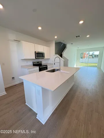 a view of a dining room with furniture and a potted plant