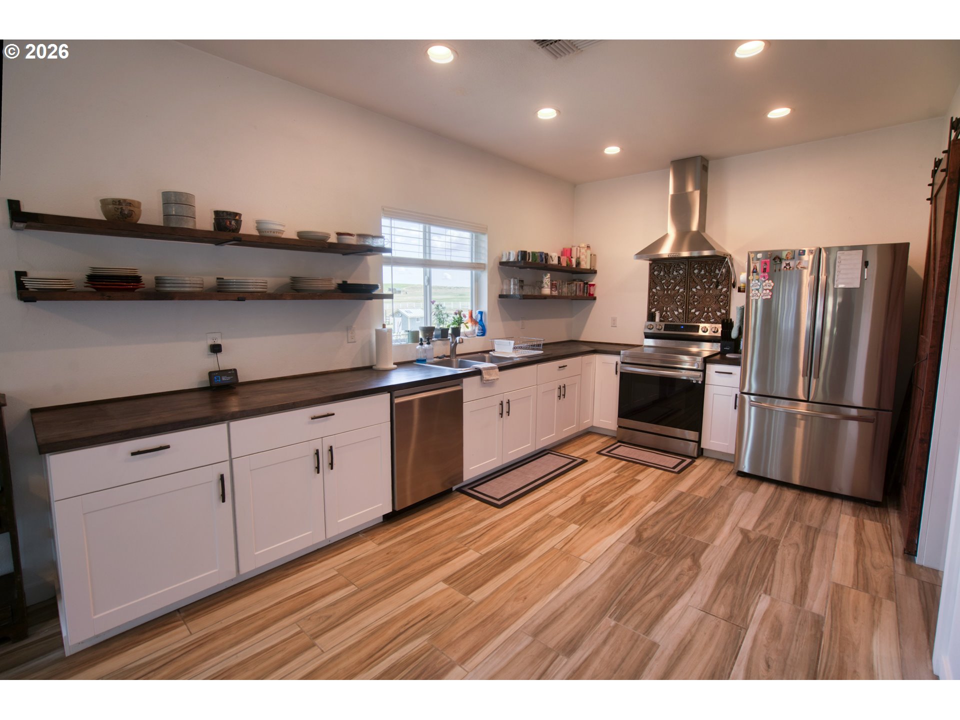 19 Inverness Road Goldendale, WA 98620 - Photo 20 of 48 a kitchen with stainless steel appliances granite countertop a sink dishwasher a refrigerator and a stove with wooden floor