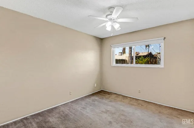an empty room with windows and cabinet