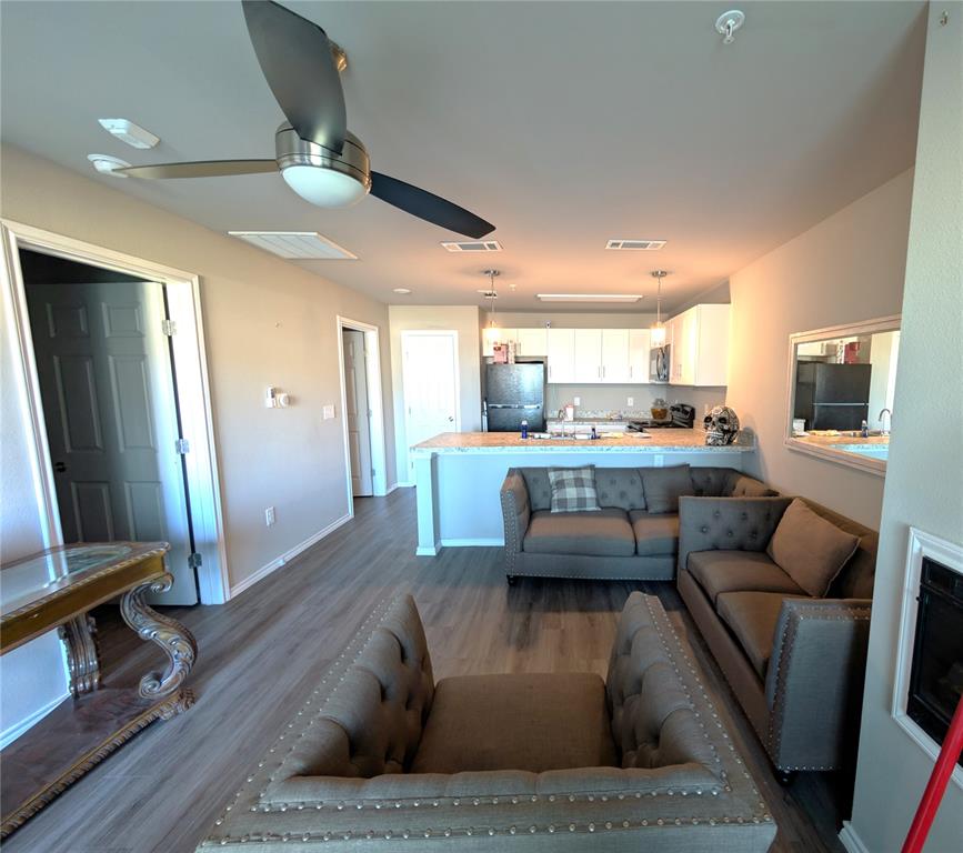 6108 Abrams Road, Unit 202 Dallas, TX 75231 - Photo 2 of 5 a living room with furniture and kitchen view