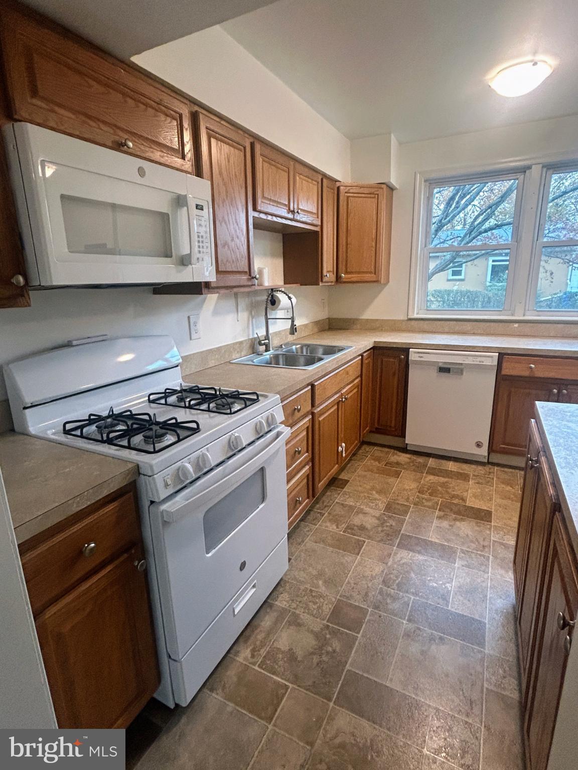 787 Pennsylvania Avenue Wallingford, PA 19086 - Photo 13 of 26 a kitchen with stainless steel appliances granite countertop a stove a sink and a microwave
