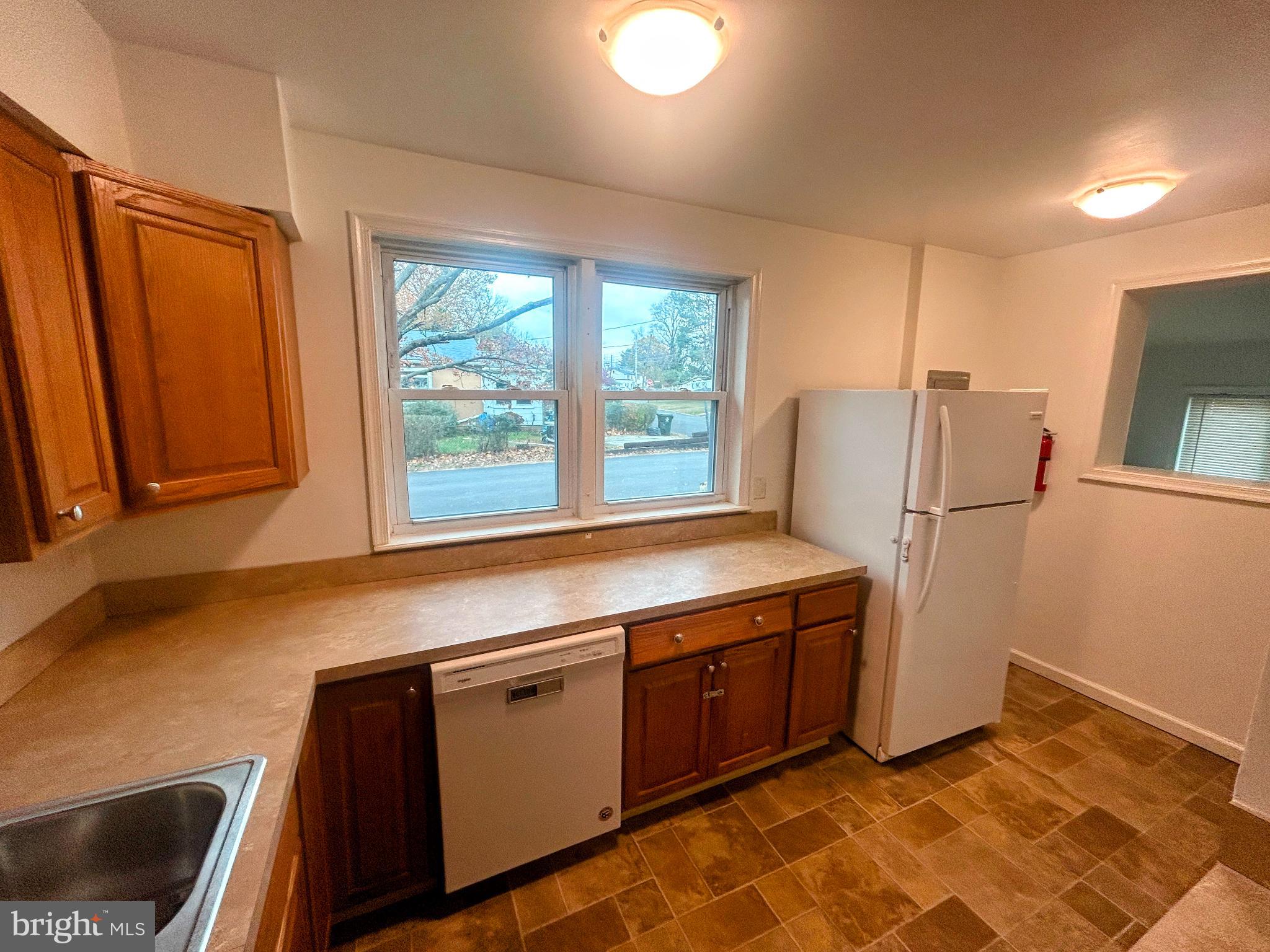787 Pennsylvania Avenue Wallingford, PA 19086 - Photo 16 of 26 a kitchen with a refrigerator and cabinets
