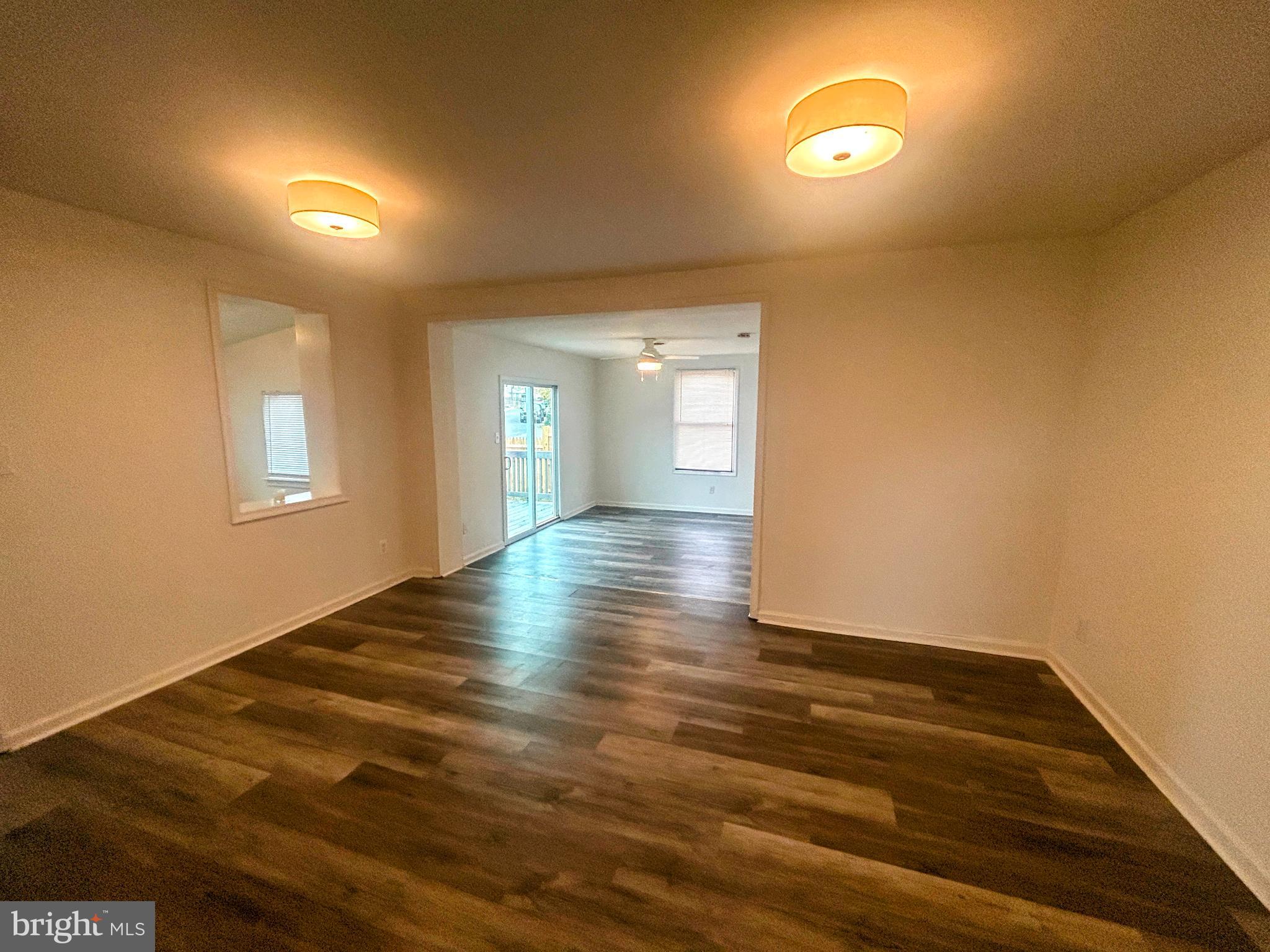 787 Pennsylvania Avenue Wallingford, PA 19086 - Photo 10 of 26 an empty room with wooden floor and windows