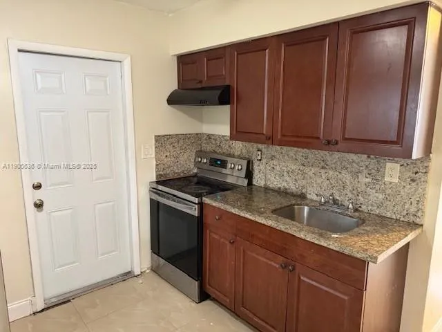 a kitchen with a sink and cabinets