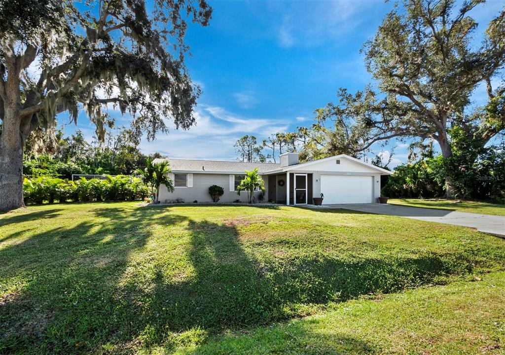 351 Carmel Road Venice, FL 34293 - Photo 1 of 1 a front view of house with yard and trees