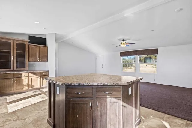 a view of kitchen with microwave a stove and cabinets