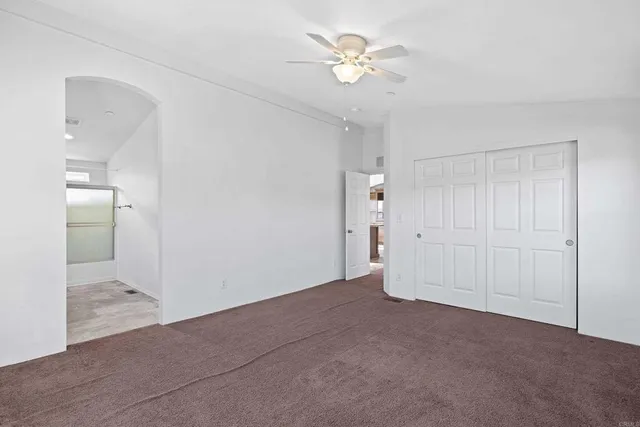 a bathroom with a granite countertop sink a mirror and a shower