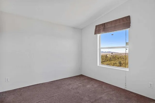 a view of an empty room and a window