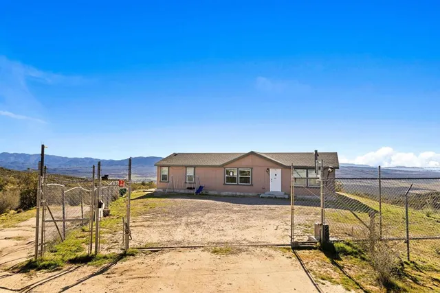 a front view of a house with wooden fence