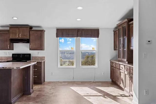 a view of a kitchen with an empty space and a window