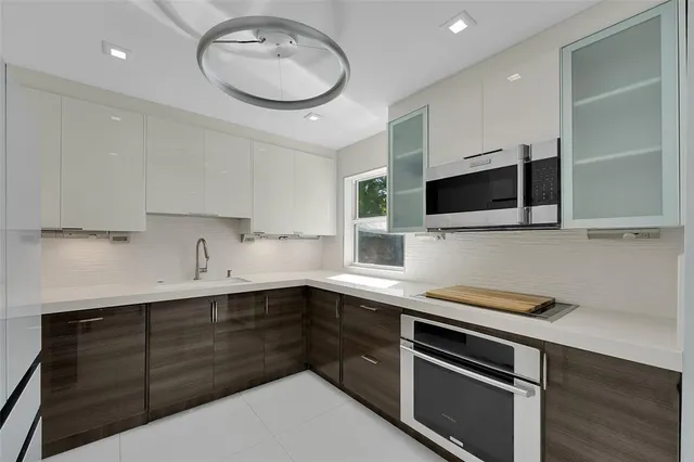 a kitchen with a sink stainless steel appliances and cabinets
