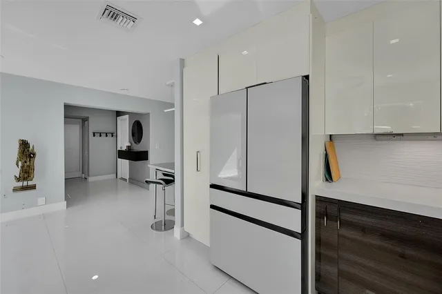a kitchen with stainless steel appliances a refrigerator and cabinets