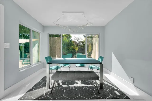 a view of a room that has a bed chair and a window