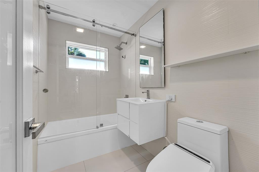 640 Northwest 30th Street Wilton Manors, FL 33311 - Photo 2 of 25 a bathroom with a sink a toilet and shower