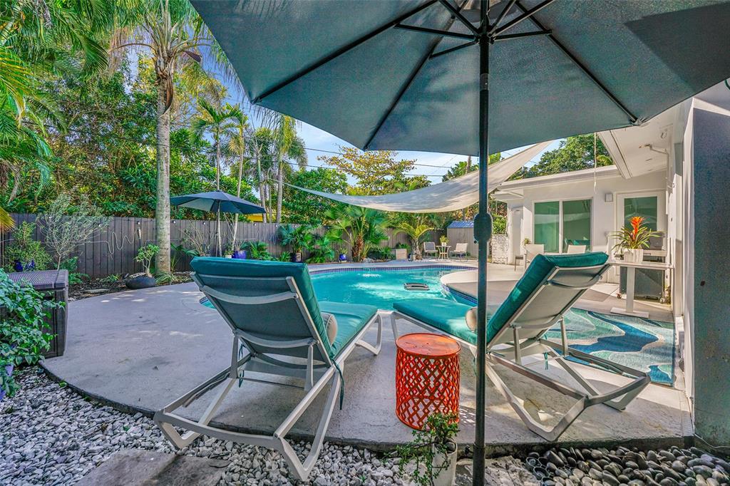 640 Northwest 30th Street Wilton Manors, FL 33311 - Photo 22 of 25 a view of a patio with table and chairs under an umbrella