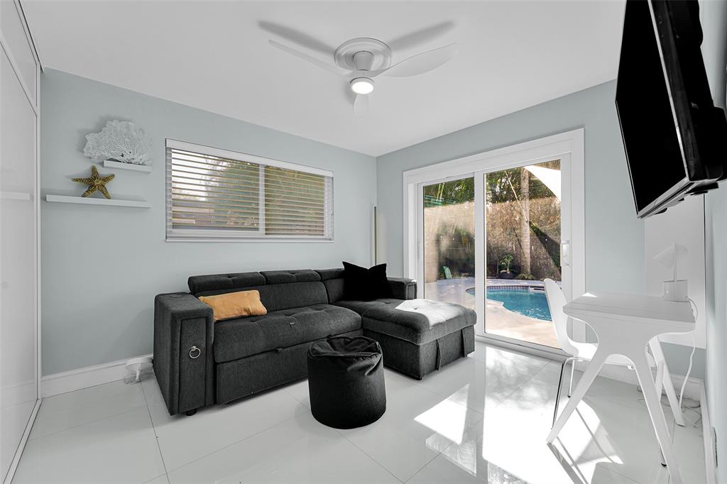 640 Northwest 30th Street Wilton Manors, FL 33311 - Photo 3 of 25 a living room with furniture and a flat screen tv