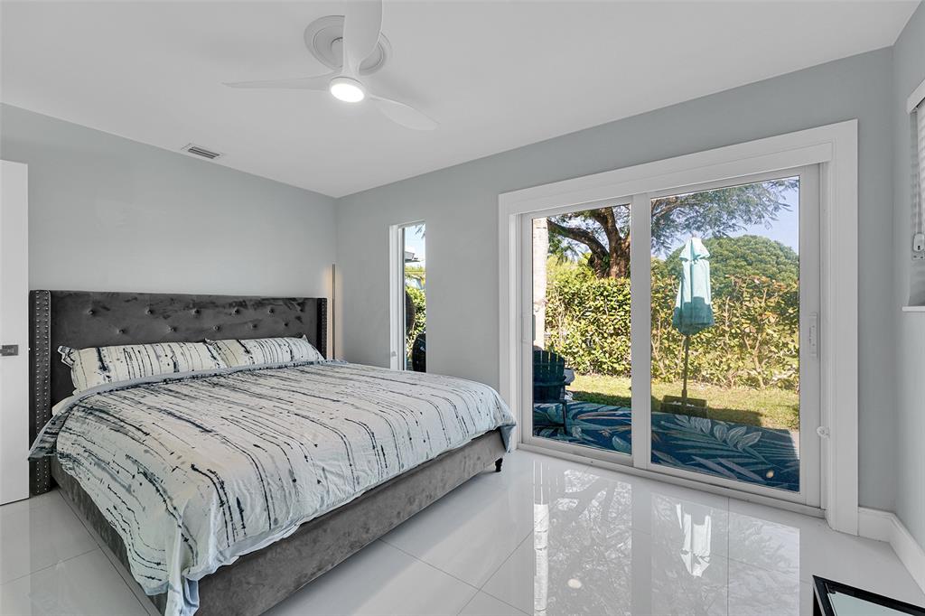 640 Northwest 30th Street Wilton Manors, FL 33311 - Photo 6 of 25 a bedroom with a large bed and a large window