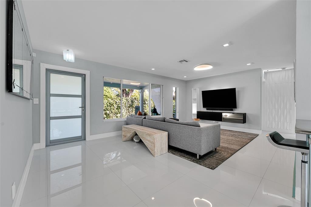 640 Northwest 30th Street Wilton Manors, FL 33311 - Photo 9 of 25 a living room with furniture and a flat screen tv