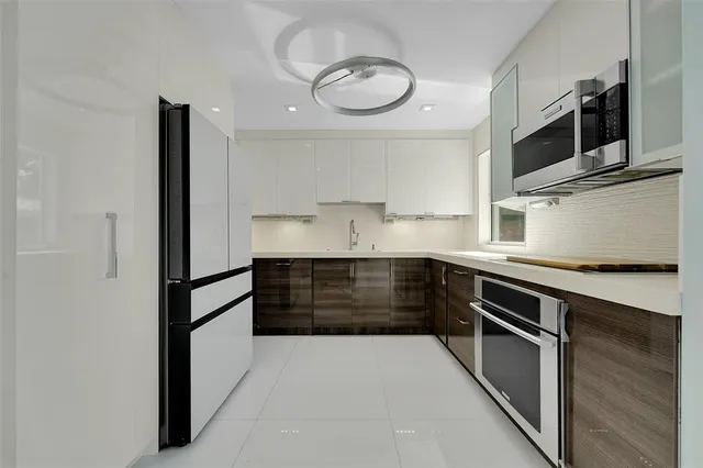 a kitchen with stainless steel appliances granite countertop a stove and a refrigerator