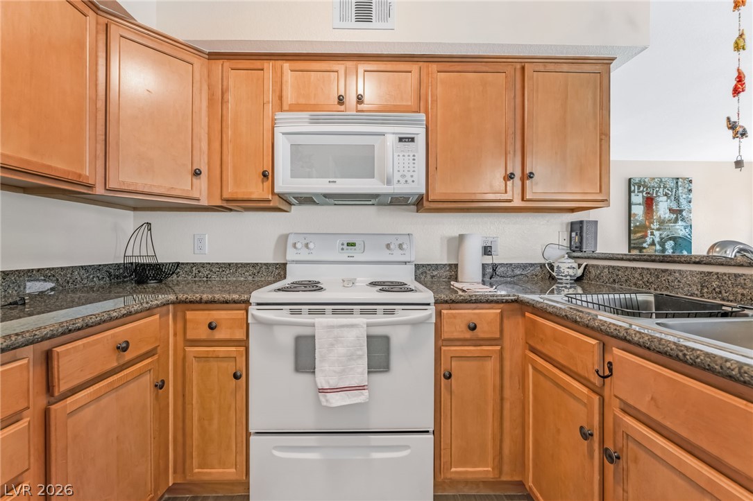 3145 East Flamingo Road, Unit 1092 Las Vegas, NV 89121 - Photo 10 of 33 Functional kitchen with ample cabinetry and a convenient counter space for meal preparation.