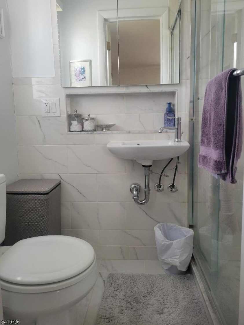 117 Tillotson Road Fanwood, NJ 07023 - Photo 24 of 30 a bathroom with a sink toilet and a mirror