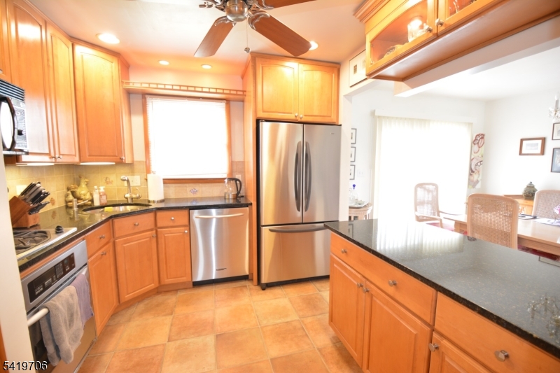117 Tillotson Road Fanwood, NJ 07023 - Photo 7 of 30 a kitchen with stainless steel appliances granite countertop a refrigerator a stove and a sink with cabinets