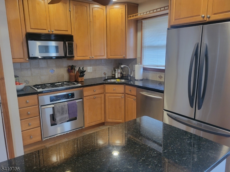 117 Tillotson Road Fanwood, NJ 07023 - Photo 10 of 30 a kitchen with stainless steel appliances granite countertop a stove a sink and a microwave