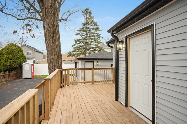 a view of balcony with wooden floor and fence