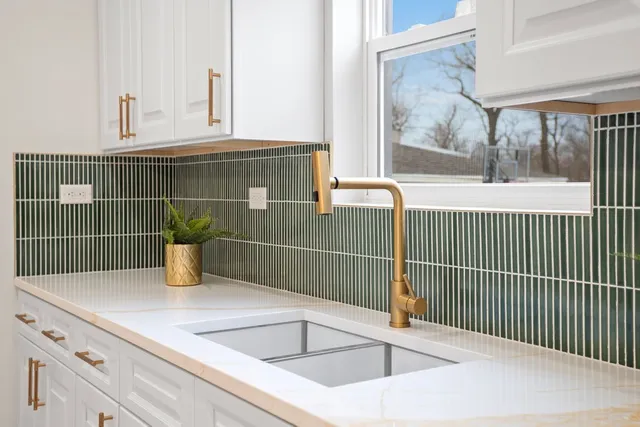 a view of a sink and window with wooden floor