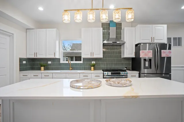 a kitchen with stainless steel appliances granite countertop a sink and cabinets