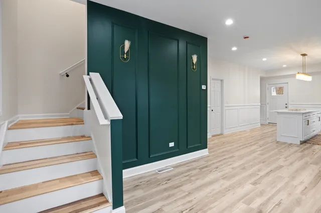 a view of entryway and hall with wooden floor