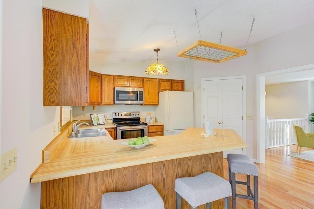68 Dothan Street Arlington, MA 02474 - Photo 11 of 42 a kitchen with a table chairs and microwave