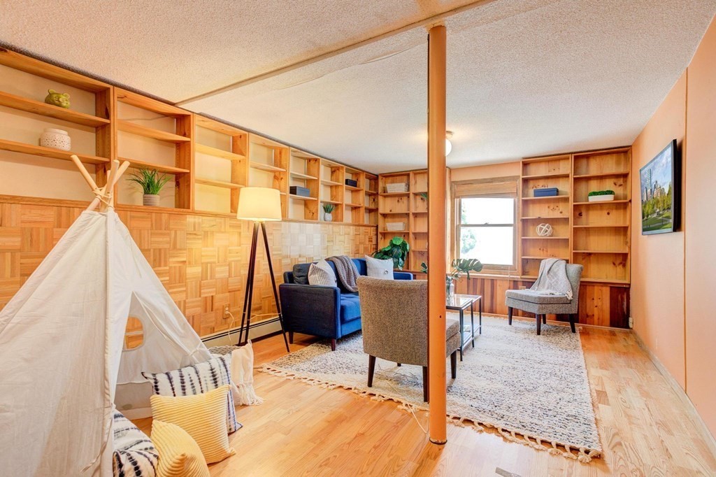68 Dothan Street Arlington, MA 02474 - Photo 19 of 42 a living room with furniture and a floor to ceiling window