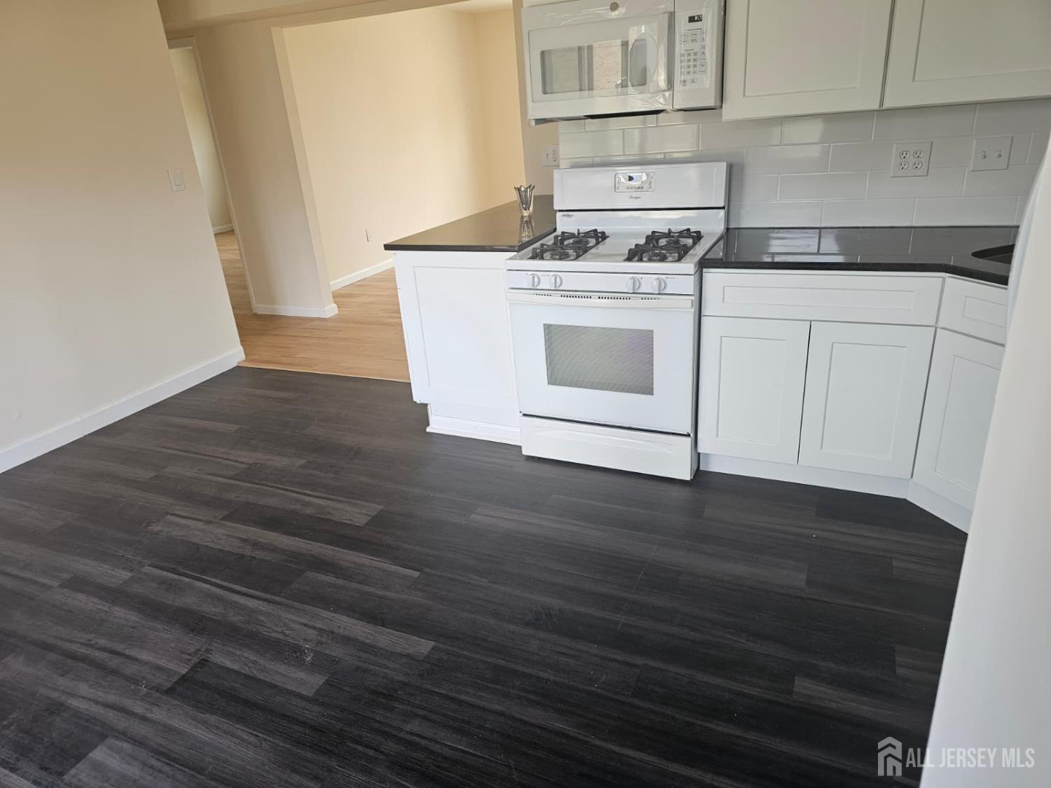 57 Judson Street, Unit 9A Edison, NJ 08837 - Photo 12 of 13 a kitchen with a stove cabinets and wooden floor
