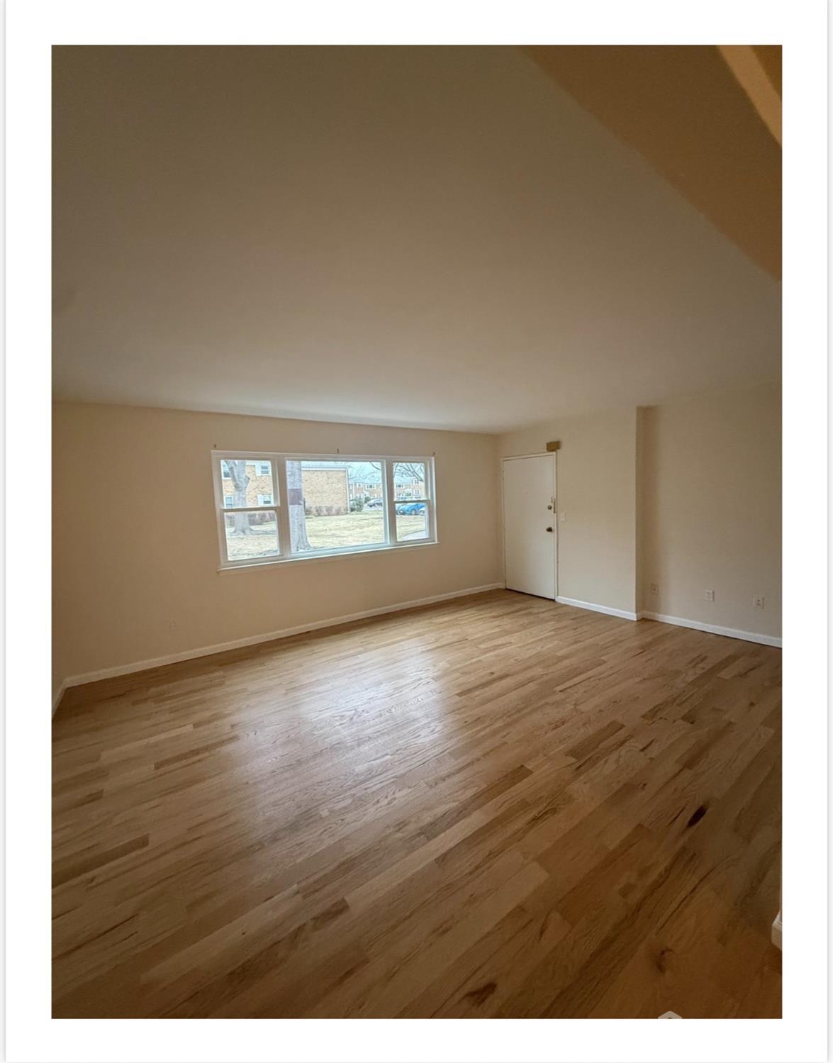 57 Judson Street, Unit 9A Edison, NJ 08837 - Photo 2 of 7 an empty room with wooden floor and windows