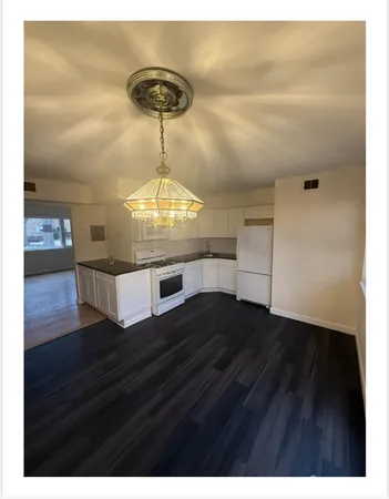 a view of kitchen and hall with wooden floor