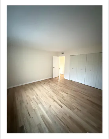 a view of an empty room and wooden floor