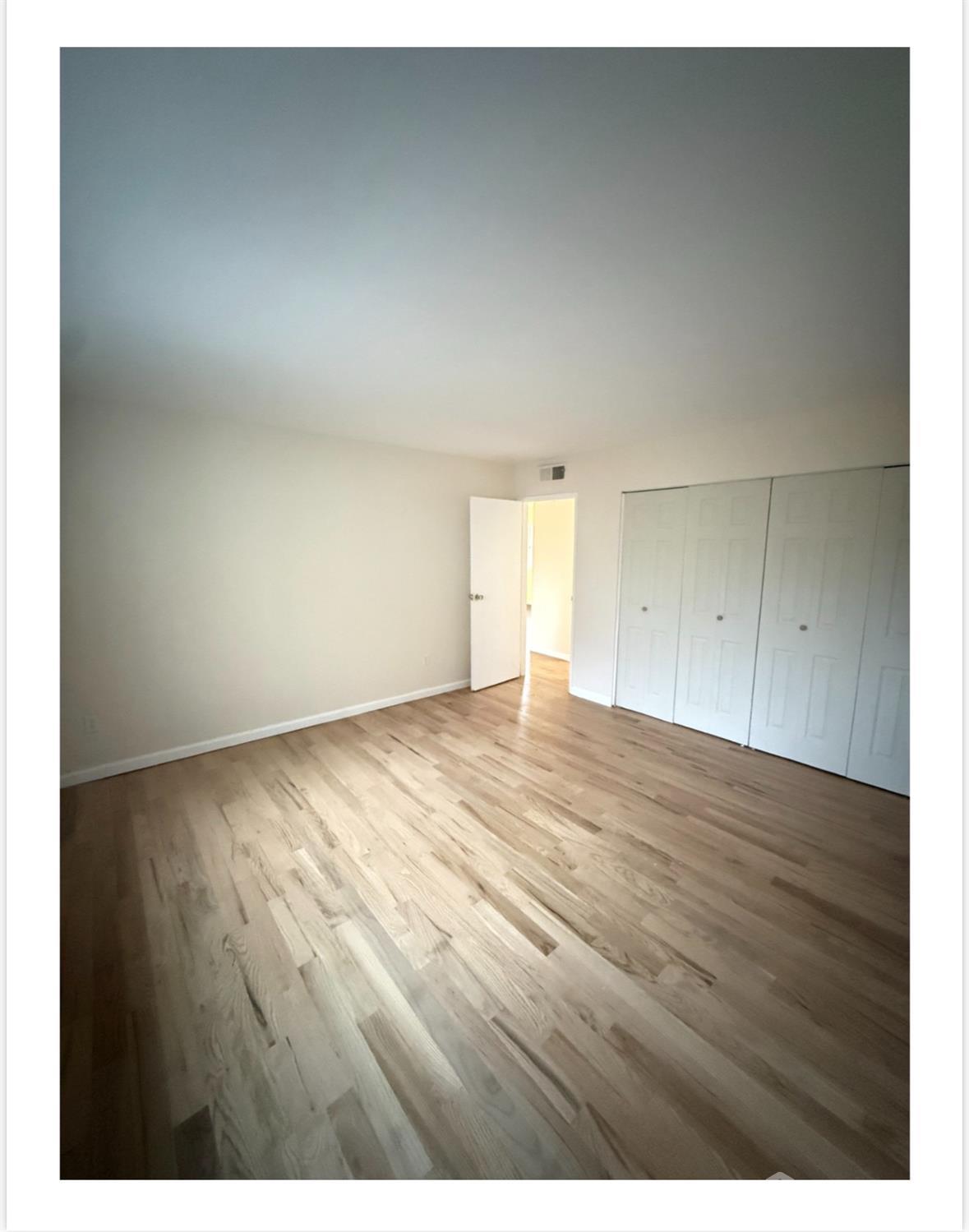 57 Judson Street, Unit 9A Edison, NJ 08837 - Photo 5 of 7 a view of an empty room and wooden floor
