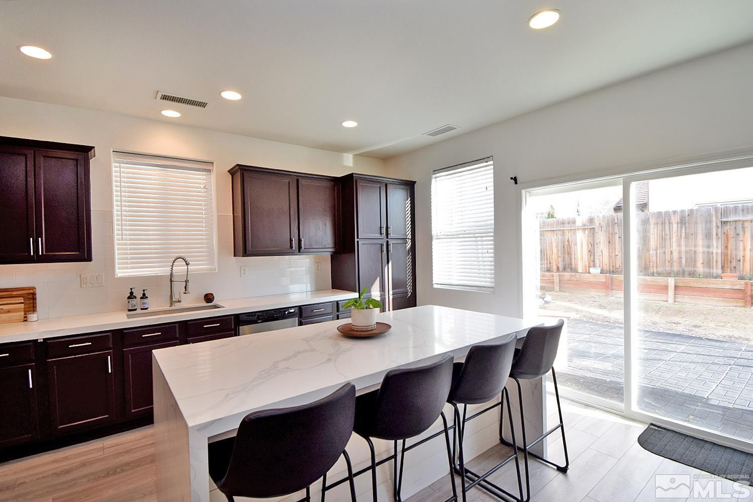 1920 Bears Ranch Drive Reno, NV 89521 - Photo 3 of 26 a kitchen with granite countertop a sink and white cabinets