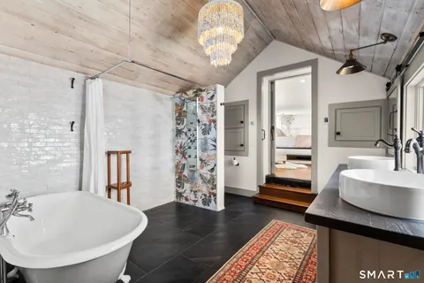 a spacious bathroom with a double vanity sink and a mirror