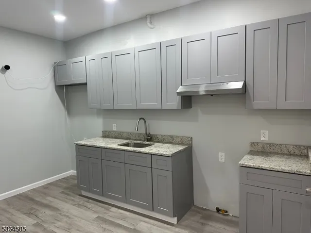 a kitchen with stainless steel appliances granite countertop a sink and cabinets
