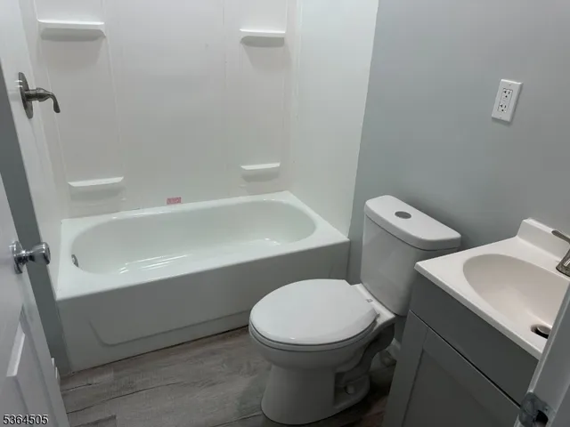 a white toilet sitting next to a bath tub
