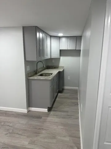 a kitchen with stainless steel appliances granite countertop a sink and a refrigerator