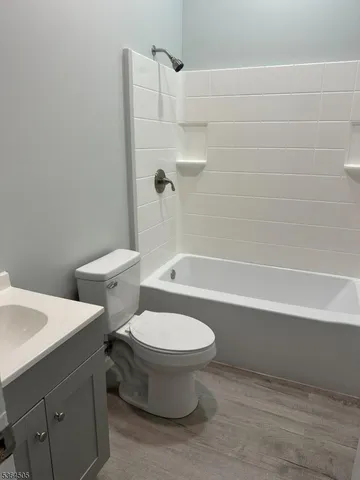a white toilet sitting next to a bath tub