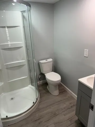 a bathroom with a toilet and a shower