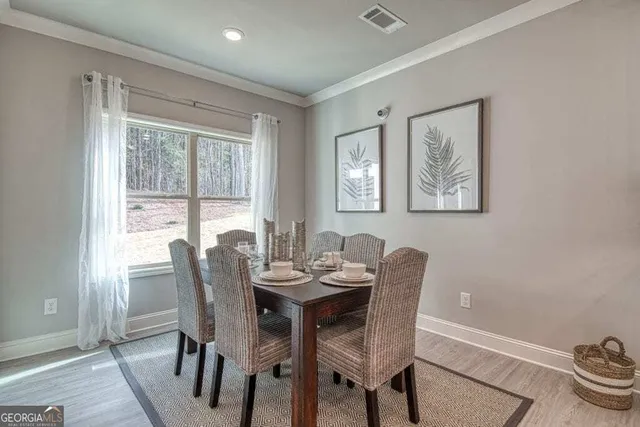 a dining room with furniture a rug and wooden floor