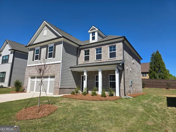 a front view of a house with a yard